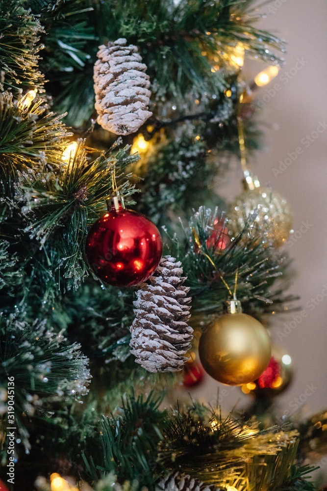 Red and golden balls on a Christmas tree with lights and bokeh. Red and golden balls on a Christmas tree with lights and bokeh.
