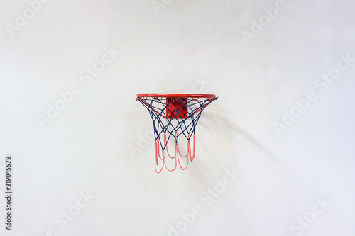 basketball hoop with net hanging on grey wall © Bonsales