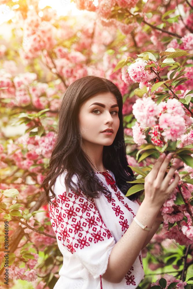 Young woman in blooming garden