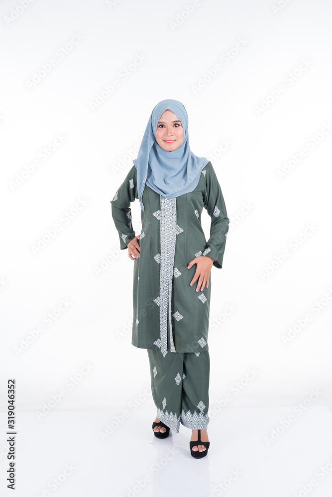 Beautiful female model in various poses wearing modern kebaya and hijab, a modern urban lifestyle apparel for Muslim women isolated on white background. Beauty and hijab fashion concept. Full length. Beautiful female model in various poses wearing modern kebaya and hijab, a modern urban lifestyle apparel for Muslim women isolated on white background. Beauty and hijab fashion concept. Full length.