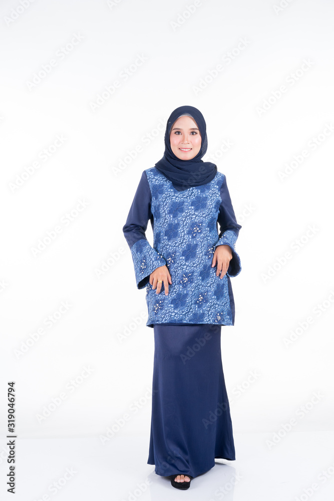 Beautiful female model in various poses wearing modern kurung and hijab, a modern urban lifestyle apparel for Muslim women isolated on white background. Beauty and hijab fashion concept. Full length. Beautiful female model in various poses wearing modern kurung and hijab, a modern urban lifestyle apparel for Muslim women isolated on white background. Beauty and hijab fashion concept. Full length.