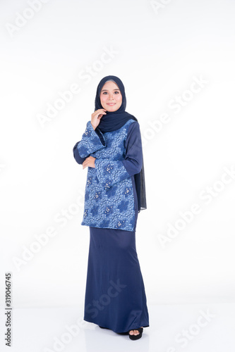 Beautiful female model in various poses wearing modern kurung and hijab, a modern urban lifestyle apparel for Muslim women isolated on white background. Beauty and hijab fashion concept. Full length. © HEMINXYLAN