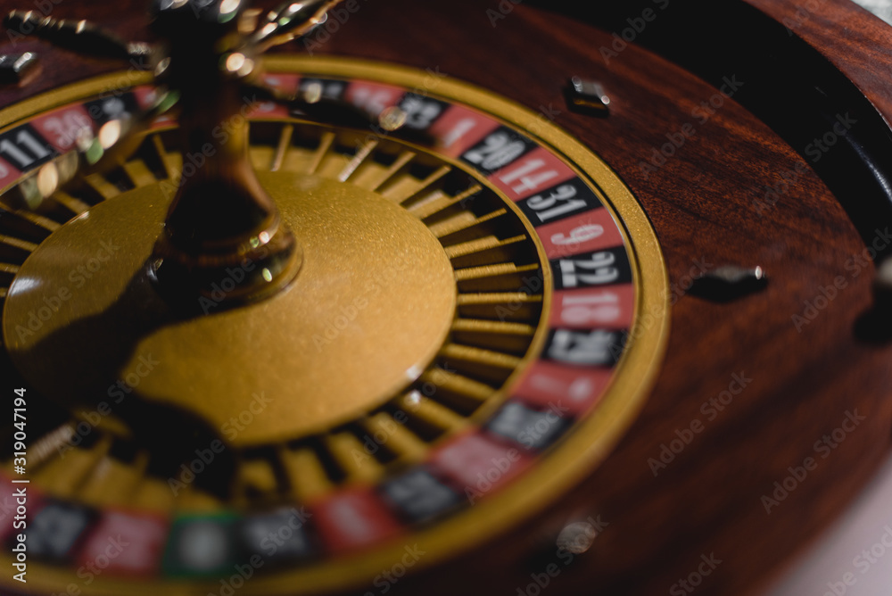Roulette table with chips in casino. Roulette wheel in the foreground. Gamble game. Roulette table with chips in casino. Roulette wheel in the foreground. Gamble game.