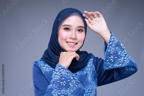 Headshot portrait of a beautiful female Muslim model with hijab in various poses  a modern urban lifestyle apparel for Muslim women isolated on grey background. Beauty and hijab fashion concept.