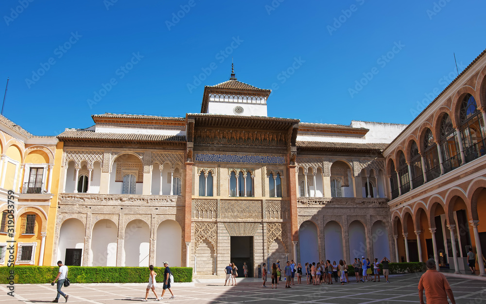 Royal Alcazar Place in Seville, Andalusia, Spain. People on the background
