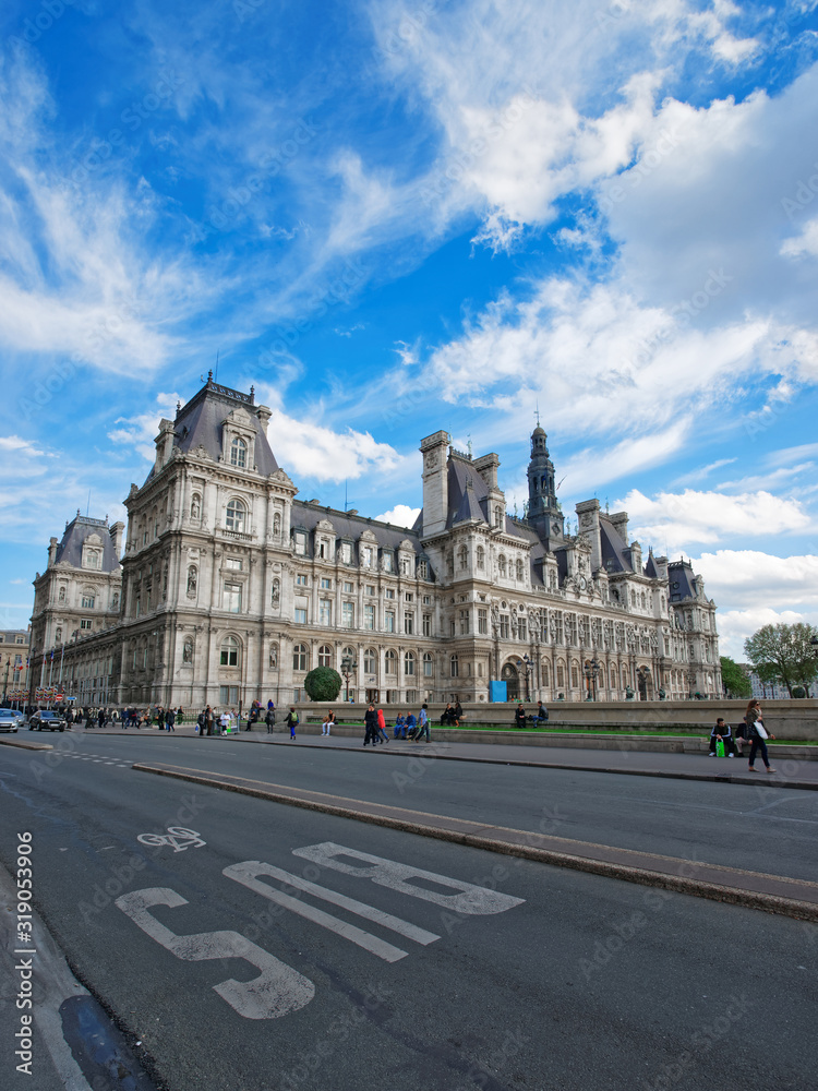 Louvre Palace in Paris in France. It is now a museum. People on the background. View from the road.