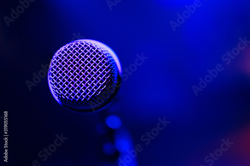 Microphone on colorful background. Close-up of retro microphone at concert.