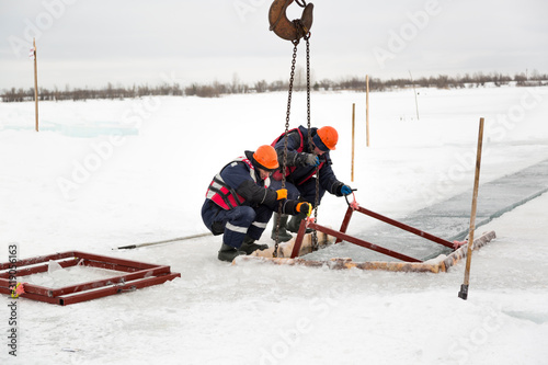 Workers catch ice blocks in the lane