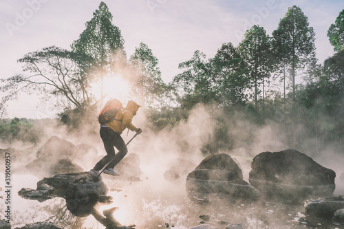 Happy tourists having fun with travel amid morning fog over hot spring at Chae Sorn National Park, Thailand photo