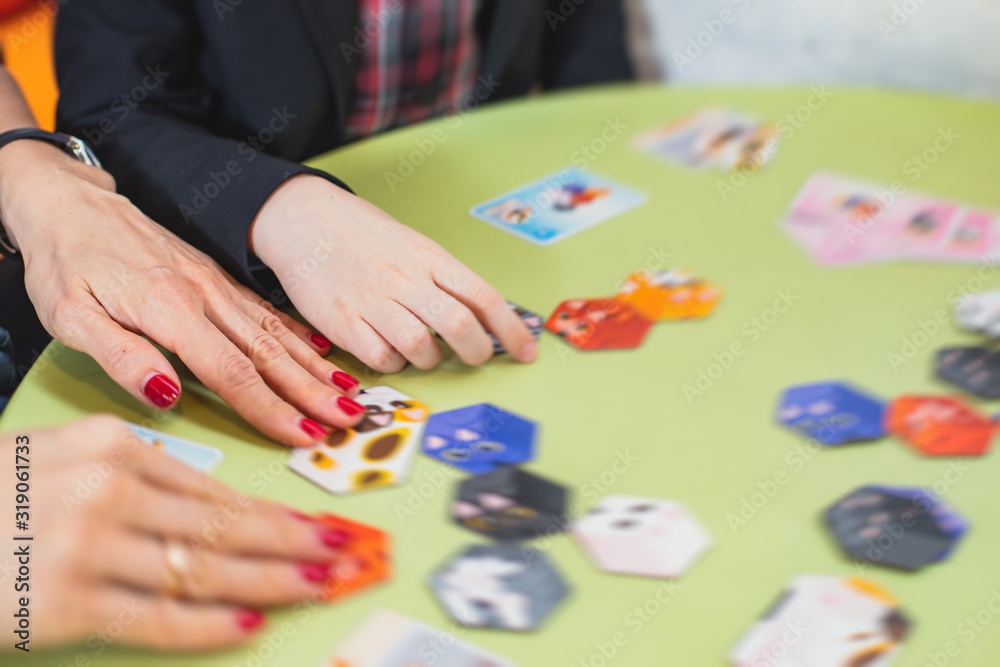 Process of playing board game and having fun with friends and family, board game concept, hand playing and roll the dice Process of playing board game and having fun with friends and family, board game concept, hand playing and roll the dice