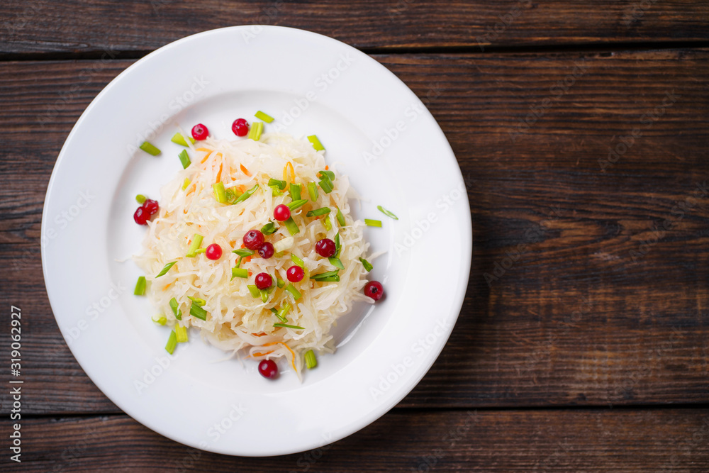 Pickled cabbage with carrots and cranberries. Preserved food, tasty snack, fermented product Pickled cabbage with carrots and cranberries. Preserved food, tasty snack, fermented product