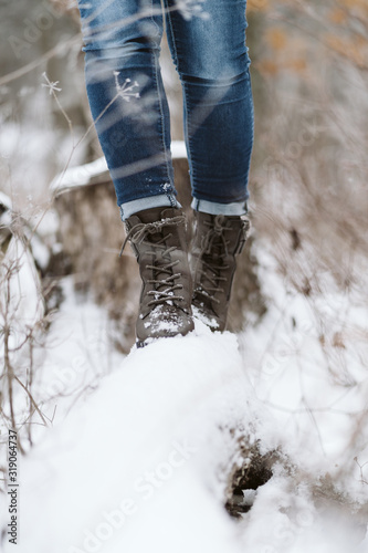 woman walking along a long in the cold winter snow