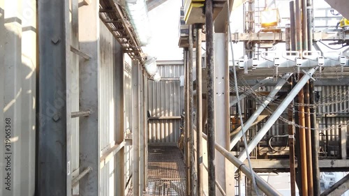 Walking around the derrick of the offshore drilling rig to money board, fingers, and pipe racking system photo