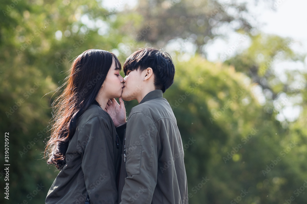 A couple of gay woman holding hands each other and kissing. Moments Happiness Concept A couple of gay woman holding hands each other and kissing. Moments Happiness Concept