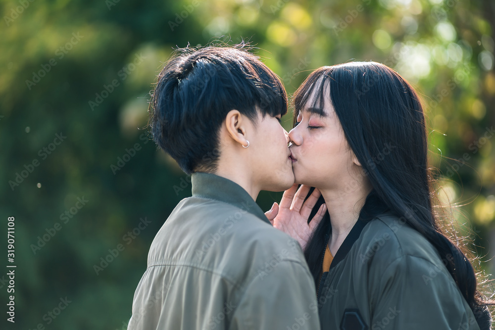 A couple of gay woman holding hands each other and kissing. Moments Happiness Concept A couple of gay woman holding hands each other and kissing. Moments Happiness Concept