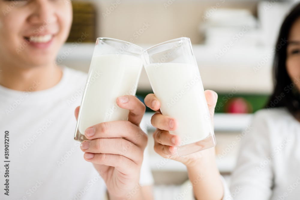Happy Married lover couple eating breakfast at home.Lover couple wear white t shirt and holding fork and knife ready for breakfast.