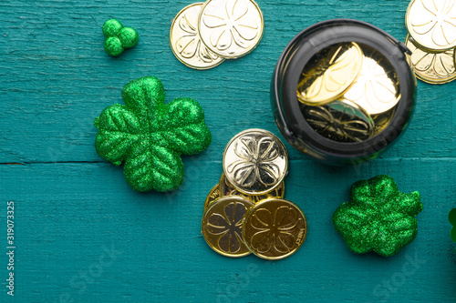 March 17, St. Patrick's Day. Irish holiday, Flat lay green background with coins, clover. Old traditional festivals.