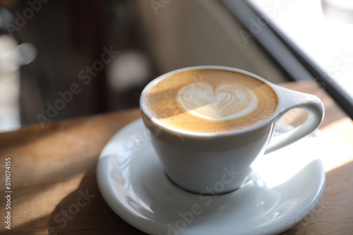 cappuccino or Latte art coffee made from milk on the wood table in coffee shop