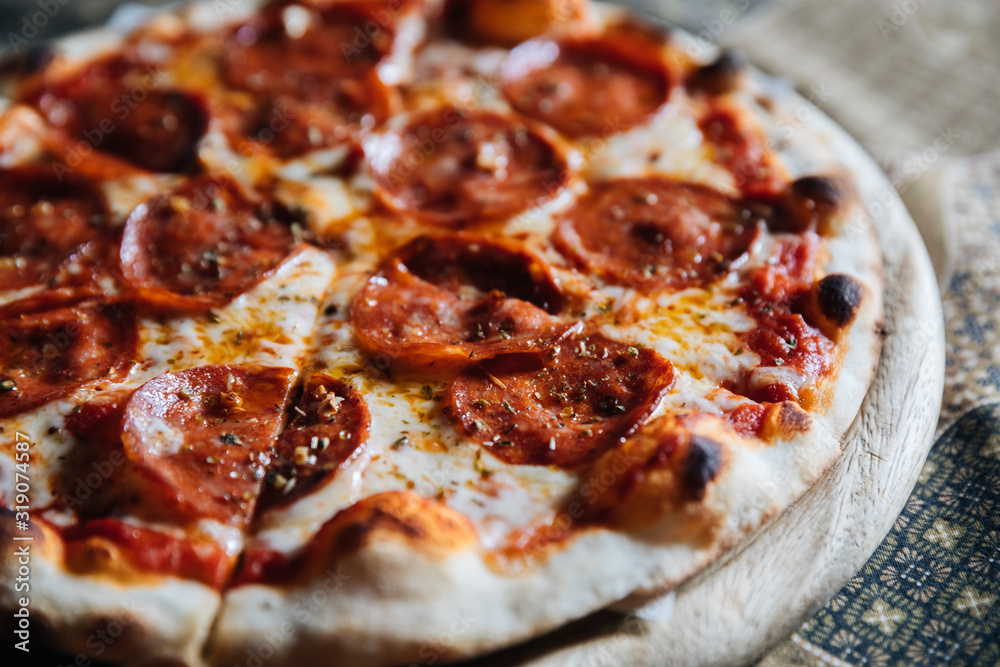 Pepperoni pizza on wood plate italian food Pepperoni pizza on wood plate italian food