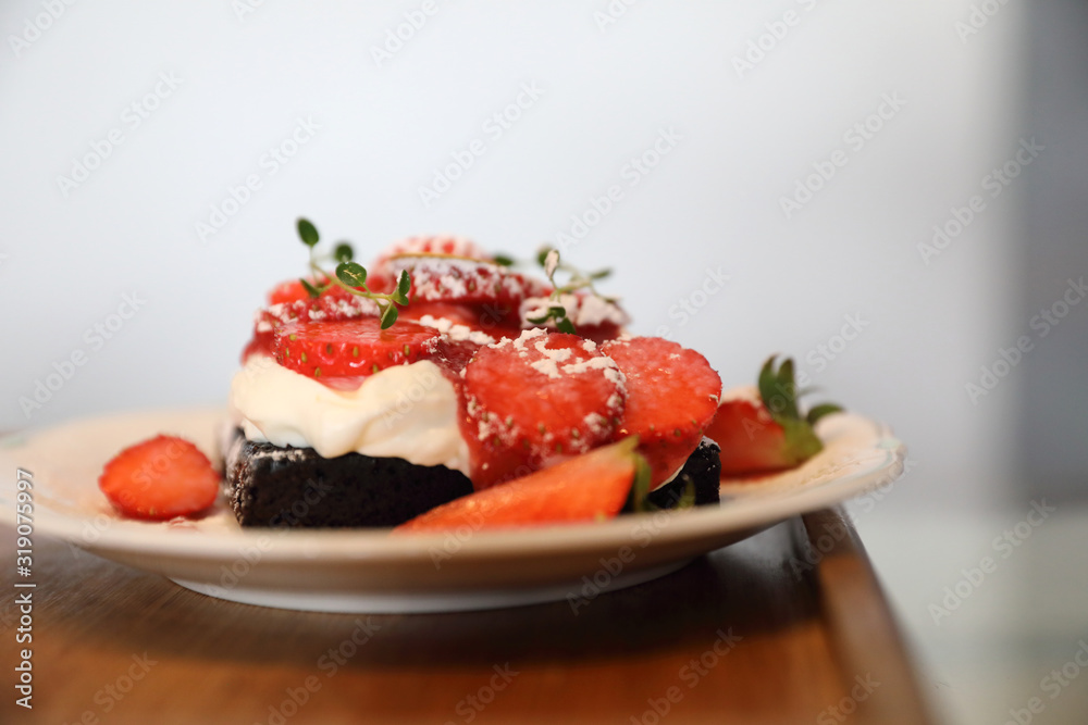 strawberry cream cake on wooden tray strawberry cream cake on wooden tray