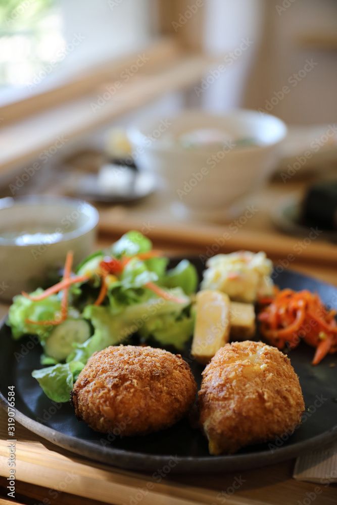 Beef Croquette with rice and salad japanese style Korokke on wooden