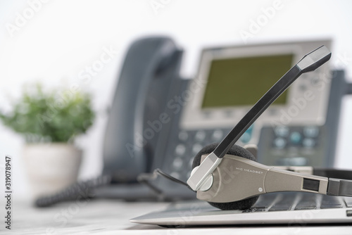 VOIP headset for headphones, concept of phone support on laptop, call center and support service. Business background
