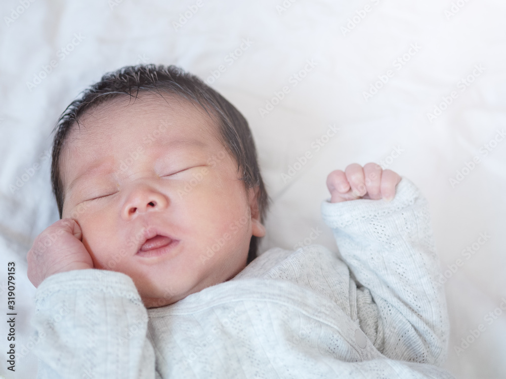 Closeup a baby sleeping comfortably on the bed Closeup a baby sleeping comfortably on the bed