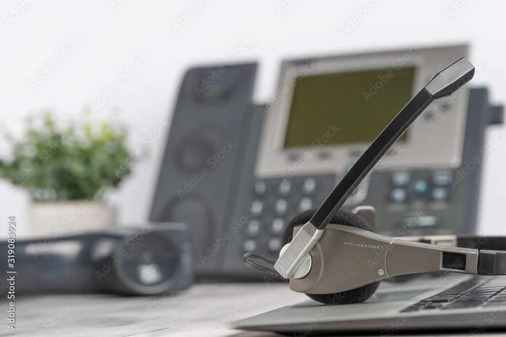 VOIP headset headphones telephone on laptop on office desk concept for  communication, it support, call center and customer service help desk.  Business center background, phone support service calls. Stock Photo | Adobe