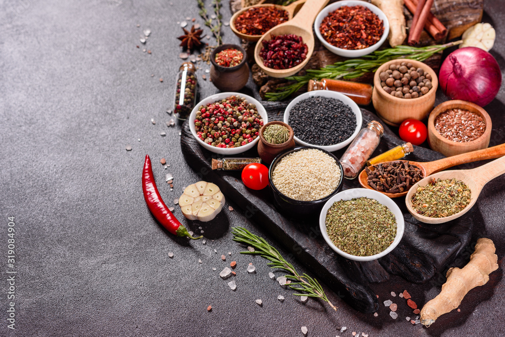 Spices and herbs over black stone background. Top view with free space for menu or recipes Spices and herbs over black stone background. Top view with free space for menu or recipes