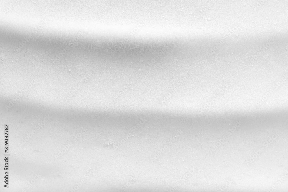 Obraz premium White foam texture close up background. Soapy substance with bubbles backdrop. Creamy grainy macro. Shower gel, washing liquid smears wallpaper. Cosmetic product foamy smudges top view