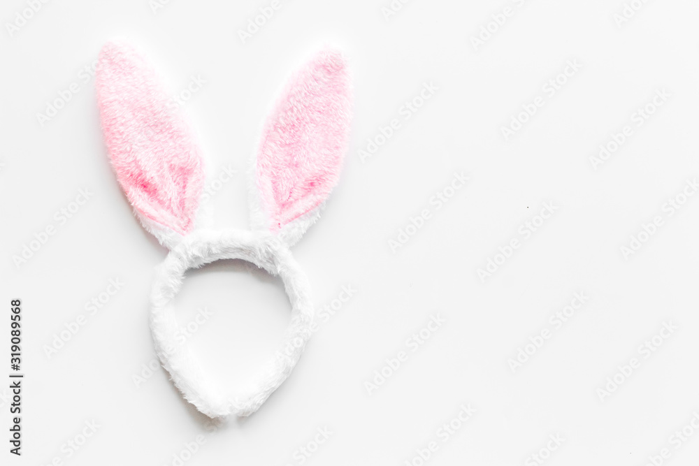Easter bunny concept. Toy rabbit's ears for head on white background top-down copy space Easter bunny concept. Toy rabbit's ears for head on white background top-down copy space