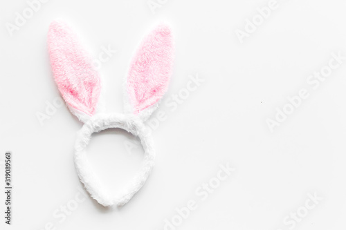 Easter bunny concept. Toy rabbit's ears for head on white background top-down copy space