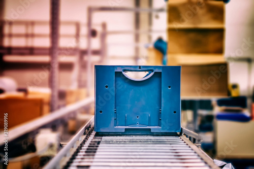 Photography Blue boxes in a large, fully automated logistics warehouse run on a conveyor belt