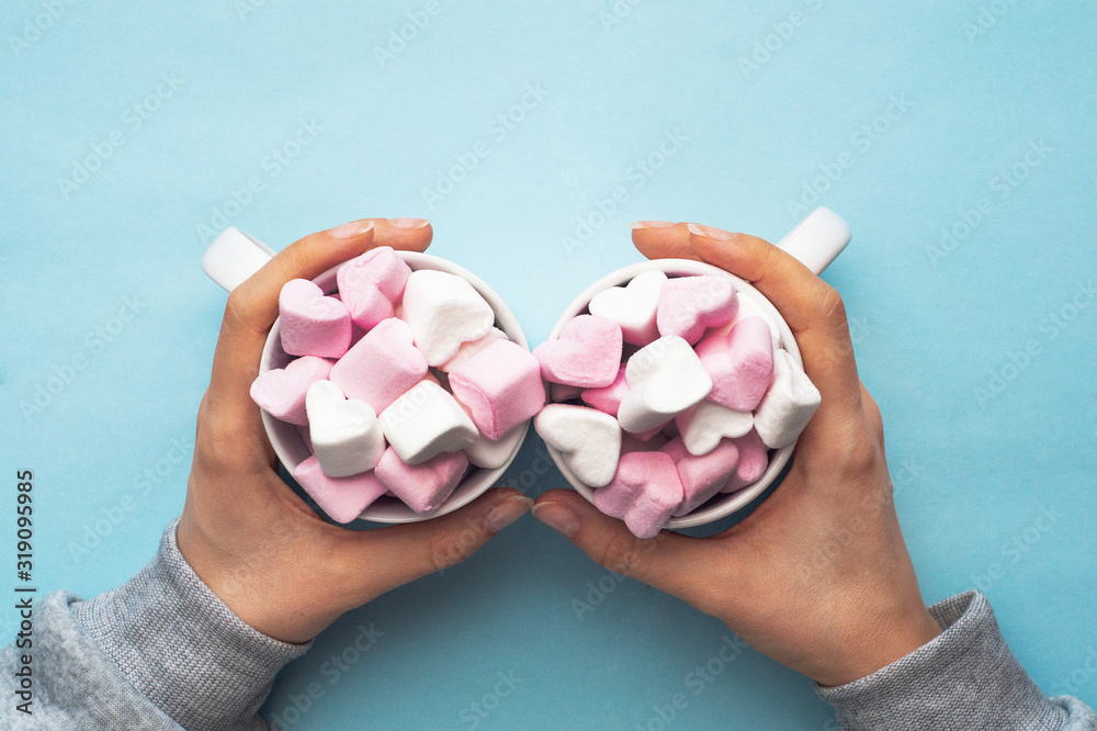 Sweet pink and white marshmallows in the form of hearts in the hands of a loving woman. Valentine day Sweet pink and white marshmallows in the form of hearts in the hands of a loving woman. Valentine day
