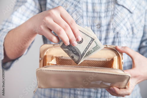 Business girl showing money with wallet.