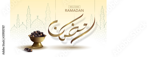 Welcome Ramadan gold calligraphy with dates fruit in the vintage brass cup. Background is islamic art pattern.