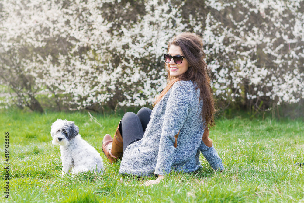 Beautiful Smiling Woman Hugging Her Cute Dog in a Spring Garden .Pet and Owner Outdoor in the Spring Beautiful Smiling Woman Hugging Her Cute Dog in a Spring Garden .Pet and Owner Outdoor in the Spring