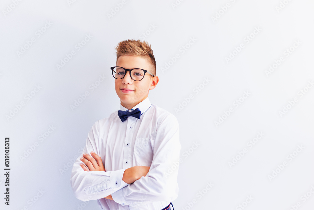 A small cheerful, cute, fashionable blond boy with glasses looks at the camera trying on glasses.The concept of health. Vision correction. Ophthalmology. A small cheerful, cute, fashionable blond boy with glasses looks at the camera trying on glasses.The concept of health. Vision correction. Ophthalmology.
