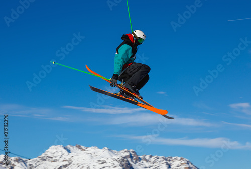 Skier jumps in snow park