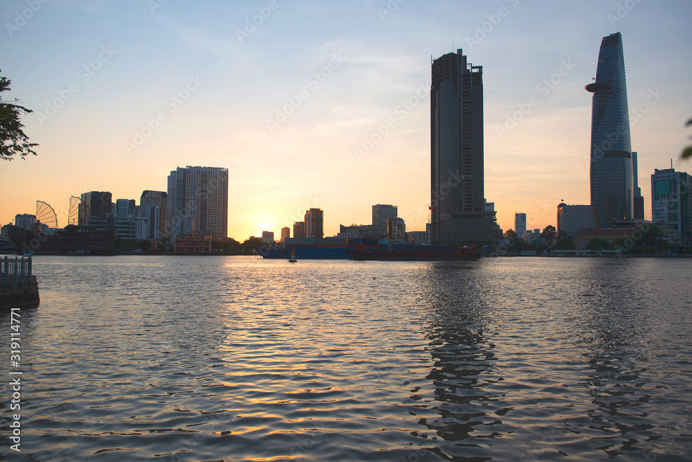  Sunset behind skyscrapers  with  reflections in the pond in Ho Chi Minh City