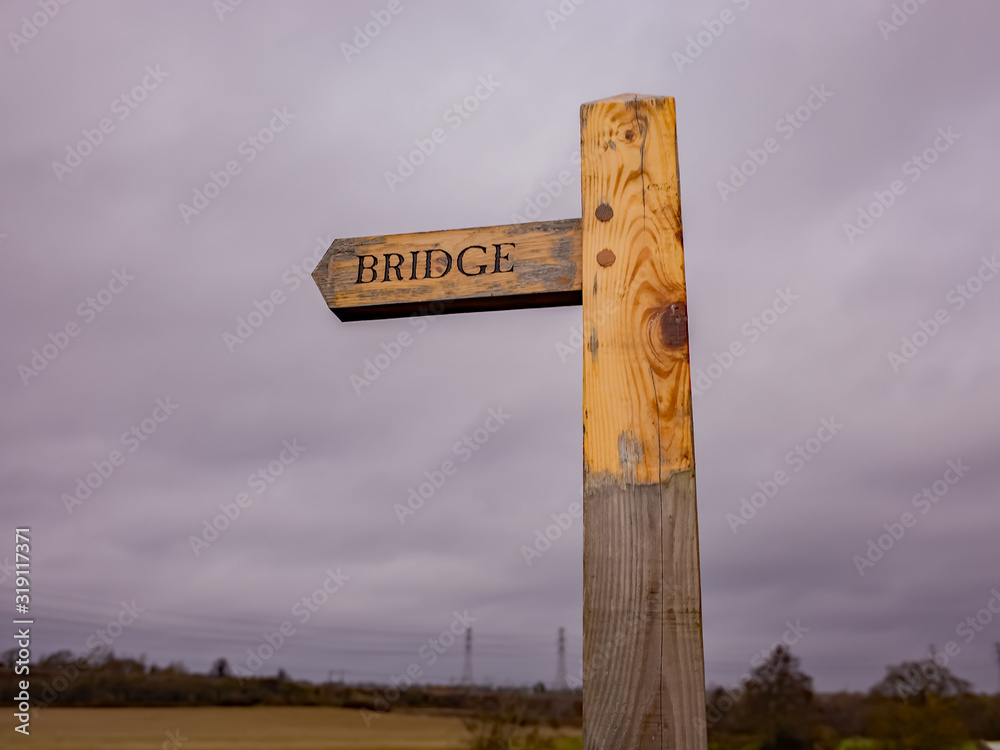 Fototapeta premium Close up of wooden bridge sign in the English countryside