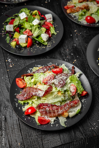 Salad with greens and bacon.Tasty, juicy, nutritious. Quick and easy to cook. Octoberfest party dinner. Festive table with delicious food