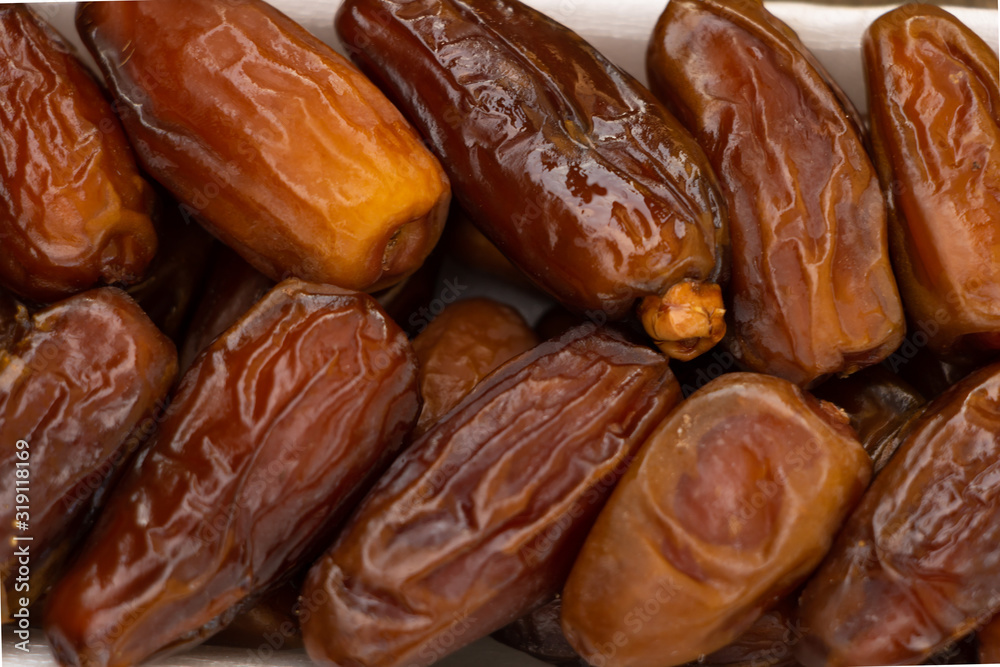 Benefits of Dates. Dried Dates on wooden background close up textured Benefits of Dates. Dried Dates on wooden background close up textured