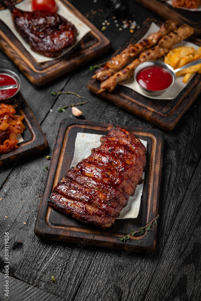 Roasted Honey Glazed Rack of Pork Ribs. Octoberfest party dinner. Festive table with delicious food on black boards. Octoberfest party dinn