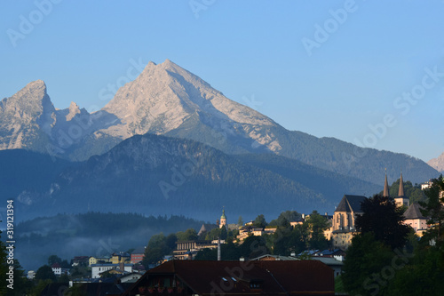 The view of Mt.Watzmann with church and houses in a summer morning. Shooting location: Salzburger Str. Berchtesgaden, Germany. The north side of the mountain.