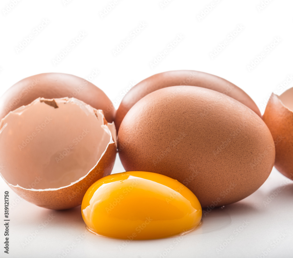 Chicken eggs and broken egg with yolk isolated on white background Chicken eggs and broken egg with yolk isolated on white background