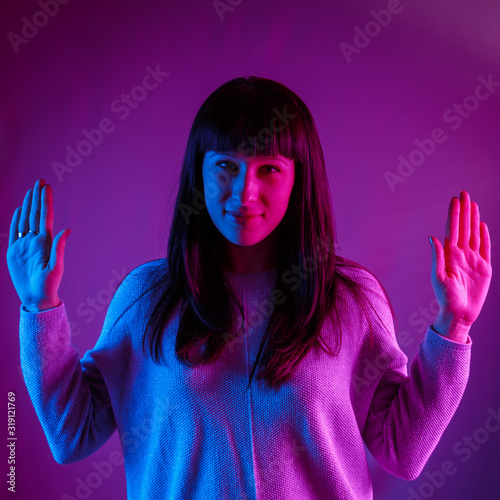 Young beautiful girl in a neon light.