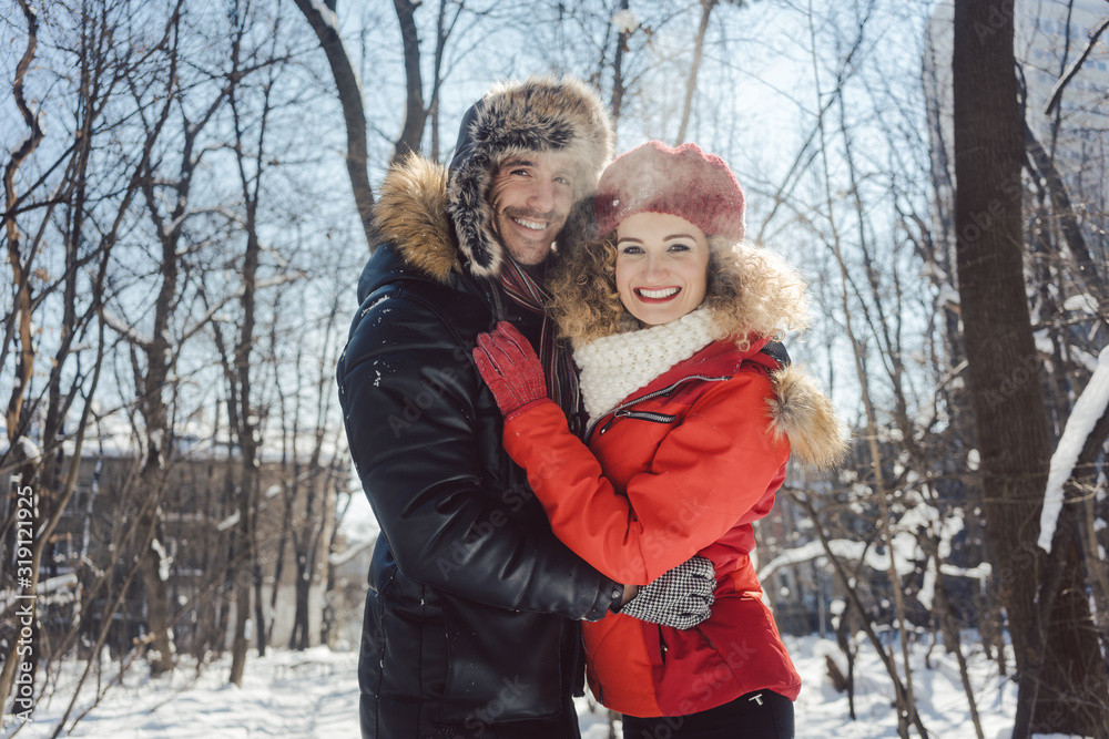 Woman and man embracing each other in winter Woman and man embracing each other in winter