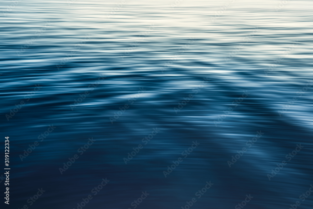 Calm water abstract background, water surface, soft blue color, play of ripples
