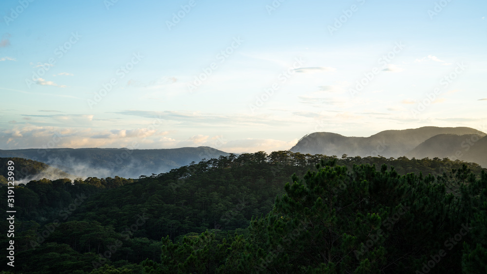 Fototapeta premium Mountain landscapes covered with forests up to the horizon in the city of Dalat in Vietnam.